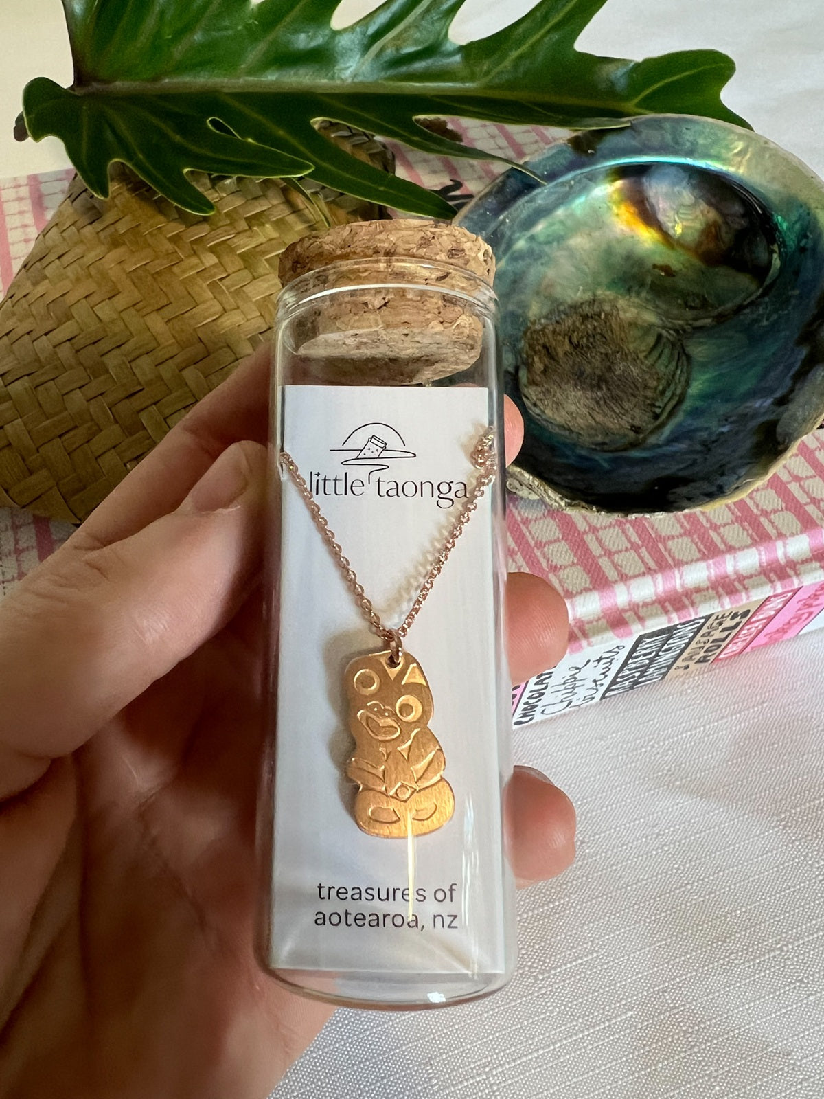Rose Gold hei tiki necklace by Little Taonga in glass gift bottle – good luck and protection pendant from New Zealand