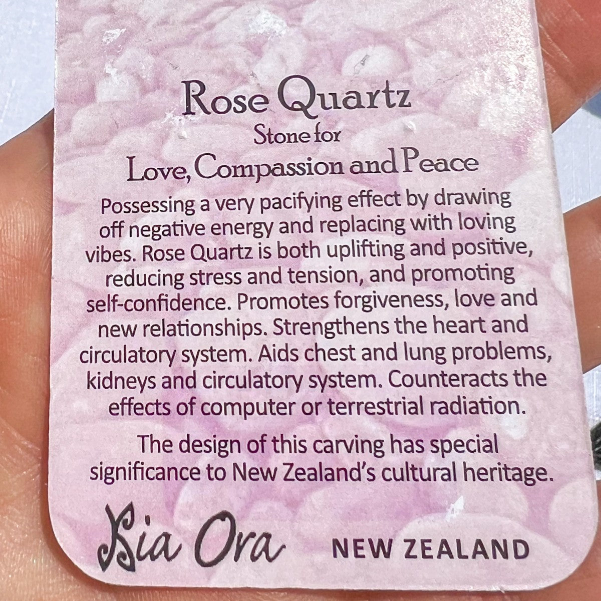Close-up of a Rose Quartz meaning card from Aotearoa New Zealand, describing the stone as one for love, compassion, and peace, promoting forgiveness, self-confidence, and calm energy.