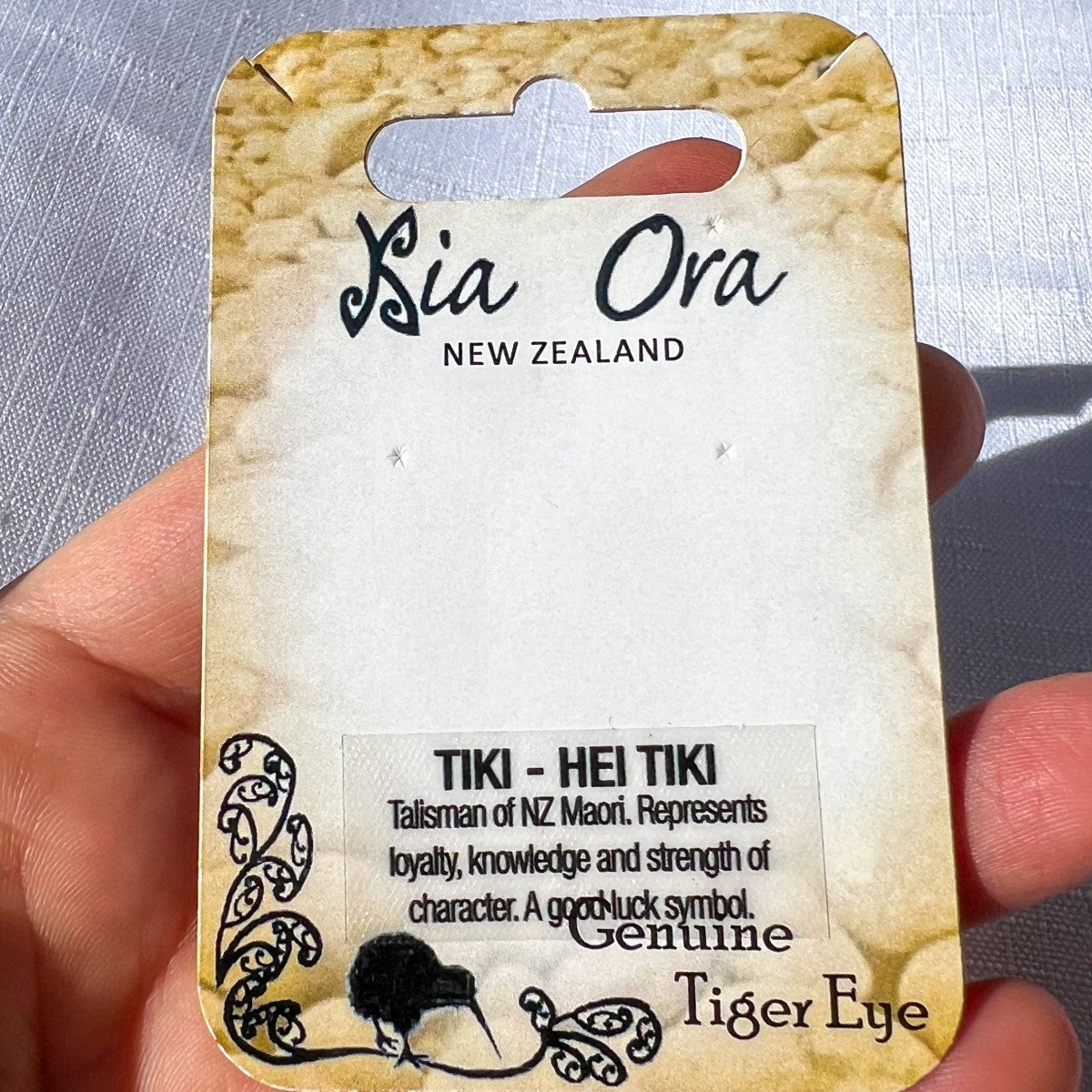 Card with 'Sia Ora New Zealand' branding and text about a Tiki - Hei Tiki talisman.