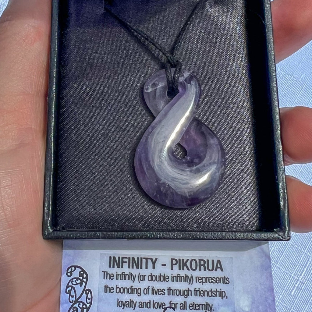 Amethyst Pikorua (infinity twist) pendant necklace on a black cord, symbolising eternal friendship, loyalty, and love — hand-carved in New Zealand.