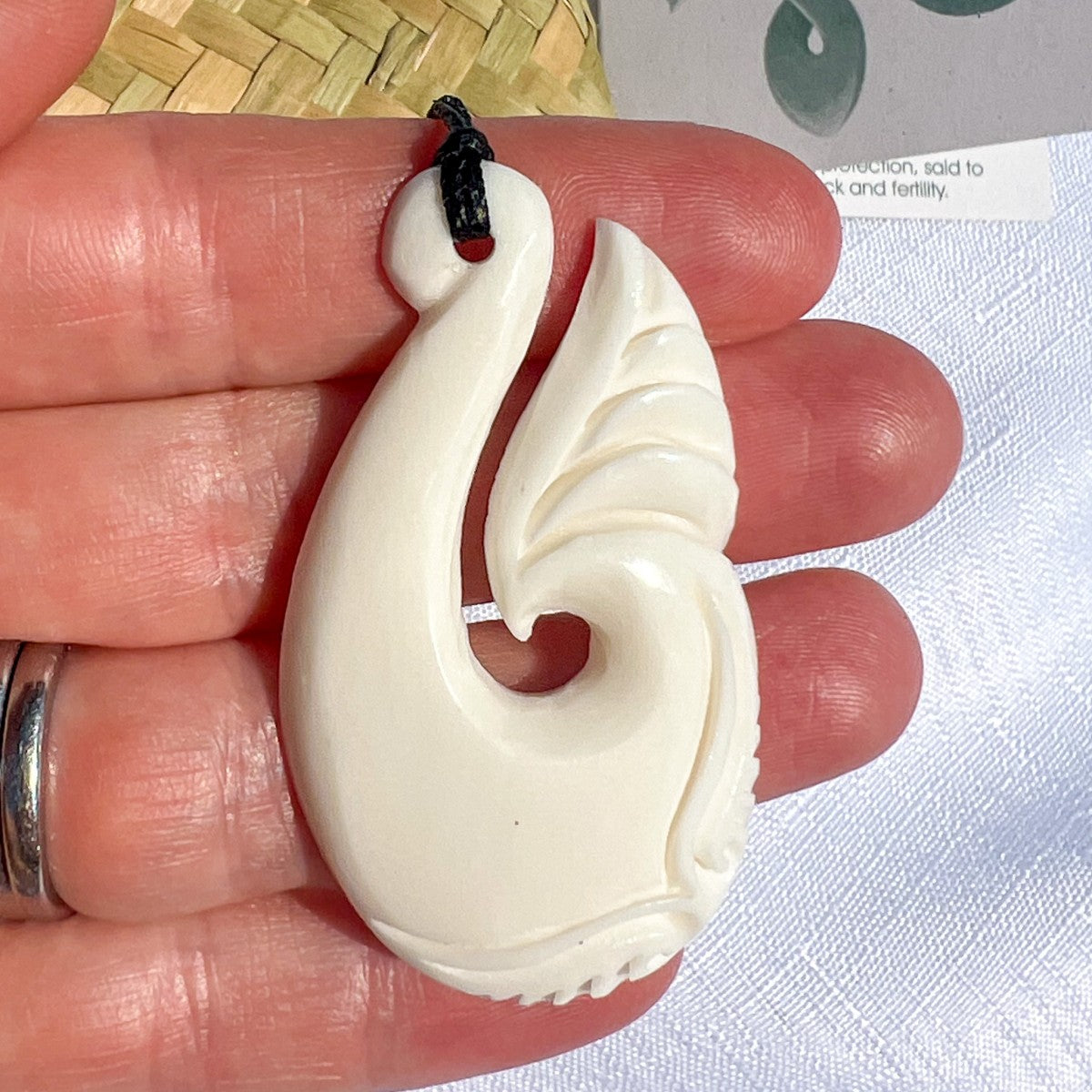 50mm bone fish hook pendant hand-carved from bovine bone – Māori hei matau design symbolising strength, prosperity, and safe journeys. Adjustable cord. Comes with organza bag. Ships fast from Australia. Free shipping on orders over $100.