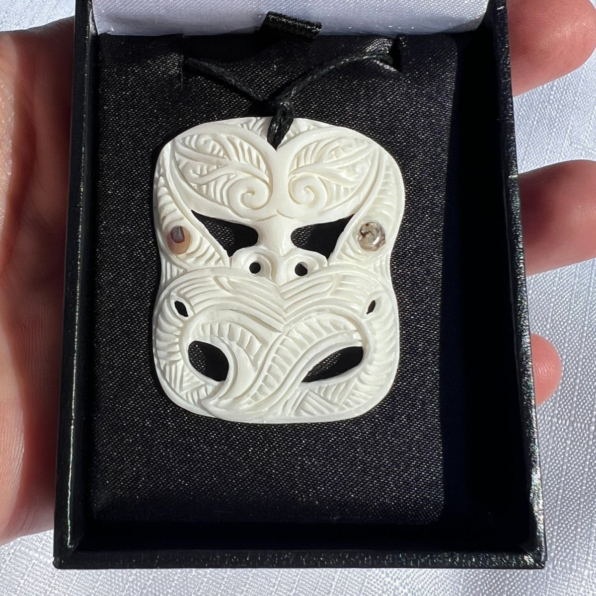 40mm bone mask pendant – hand-carved from natural bovine bone in a Māori-inspired design symbolising protection and strength. Adjustable cord. Comes with organza bag. Ships fast from Australia. Free shipping on orders over $100.