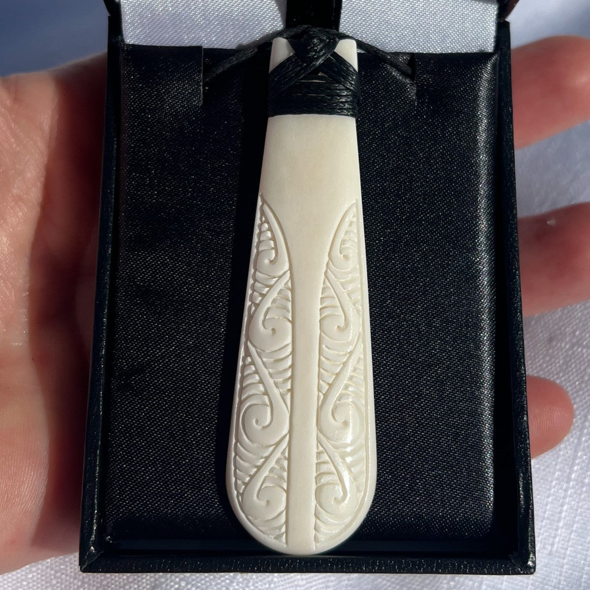 70mm engraved bone toki pendant – hand-carved from natural bovine bone in a Māori design symbolising strength and leadership. Adjustable cord. Comes with organza bag. Ships fast from Australia. Free shipping automatically included.