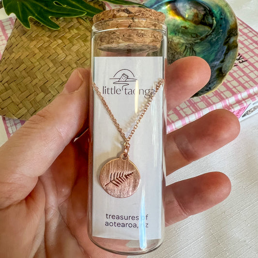 Rose gold silver fern necklace by Little Taonga in glass gift bottle – NZ symbol pendant representing strength and pride