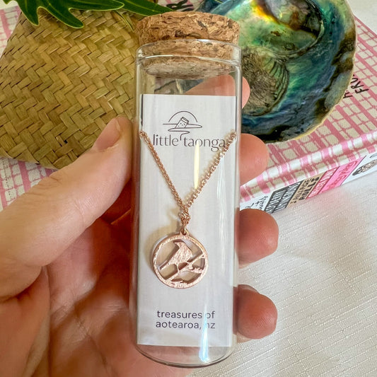 Sterling silver Tui bird necklace by Little Taonga in glass gift bottle – native New Zealand bird pendant with flax design