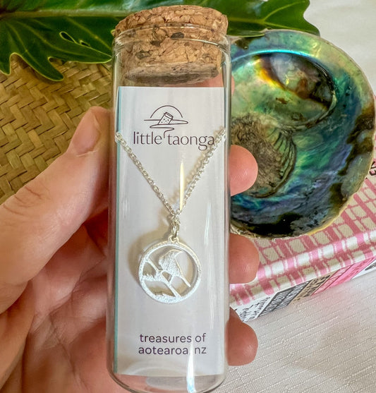 Sterling silver Tui bird necklace by Little Taonga in glass gift bottle – native New Zealand bird pendant with flax design