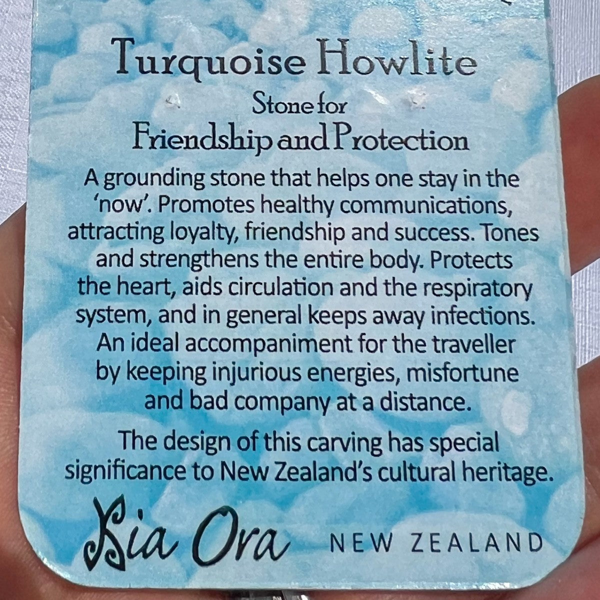Close-up of a Turquoise Howlite meaning card from Aotearoa New Zealand, describing the stone as one for friendship and protection, promoting calm, loyalty, and positive energy.