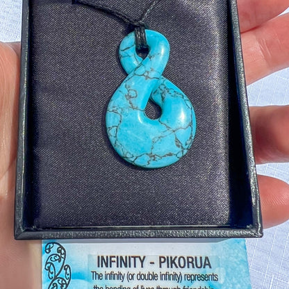 Turquoise Howlite Pikorua (infinity twist) pendant necklace on a black cord, symbolising friendship, love, and eternal connection — hand-carved in New Zealand.
