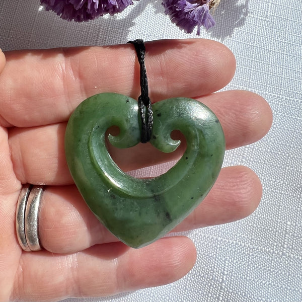 38mm New Zealand greenstone smiling heart necklace – genuine pounamu symbolising love, compassion, and positivity. Adjustable cord. Ships fast from Australia. Free shipping over $100.
